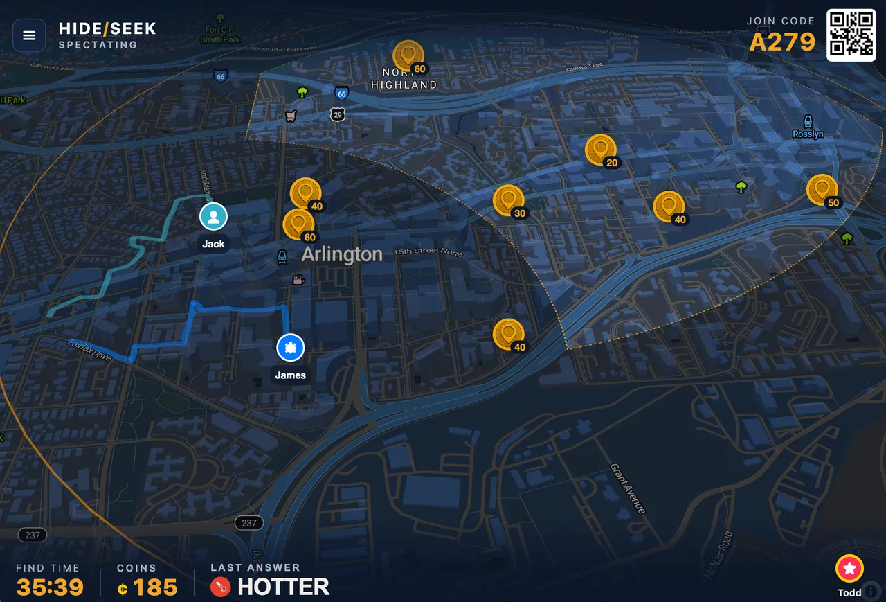 A wide browser view of the spectator screen: a dark city map with Seeker pins and their walked trails, coin pickups scattered across the play area, a join code and QR code in the top corner, and a bottom bar reading find time 35 minutes 39 seconds, 185 coins, last answer HOTTER.